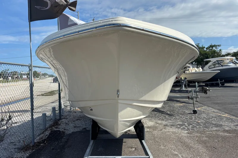 Slide: The Image of 2026 Scout 220 Dorado boat on trailer, parked outdoors under a clear sky. - 7