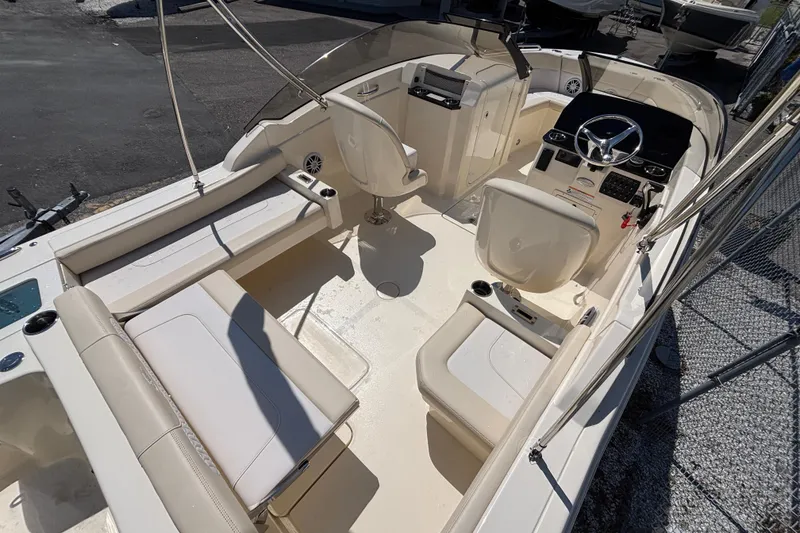 Slide: The Image of 2026 Scout 220 Dorado boat interior with seating and steering console. - 9