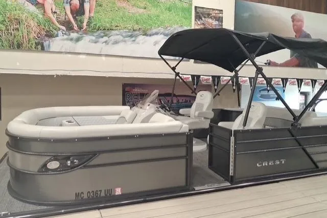 The Image of 2022 Crest Classic Platinum 220 pontoon boat with canopy in showroom display. - 0