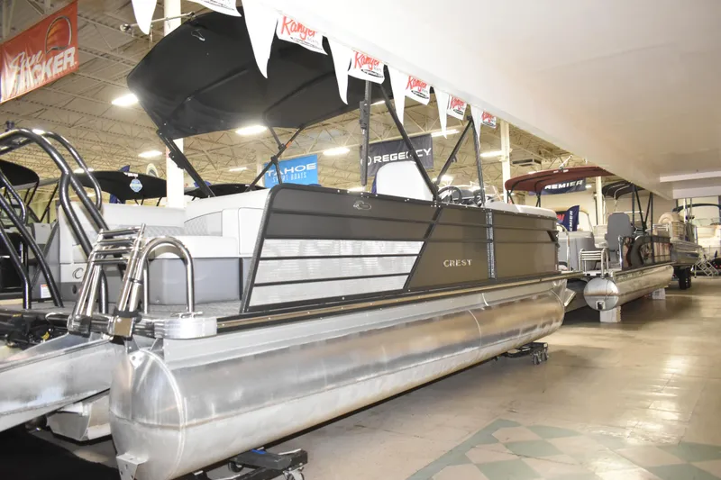 Slide: The Image of 2012 Crest 230 Prestige SLR pontoon boat displayed in a showroom. - 11