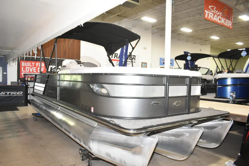 Slide: The Image of 2012 Crest 230 Prestige SLR pontoon boat displayed indoors at a showroom. - 12