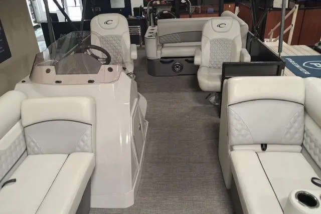 Slide: The Image of 2022 Crest Classic Platinum 220 pontoon boat interior with luxurious seating and modern helm. - 15
