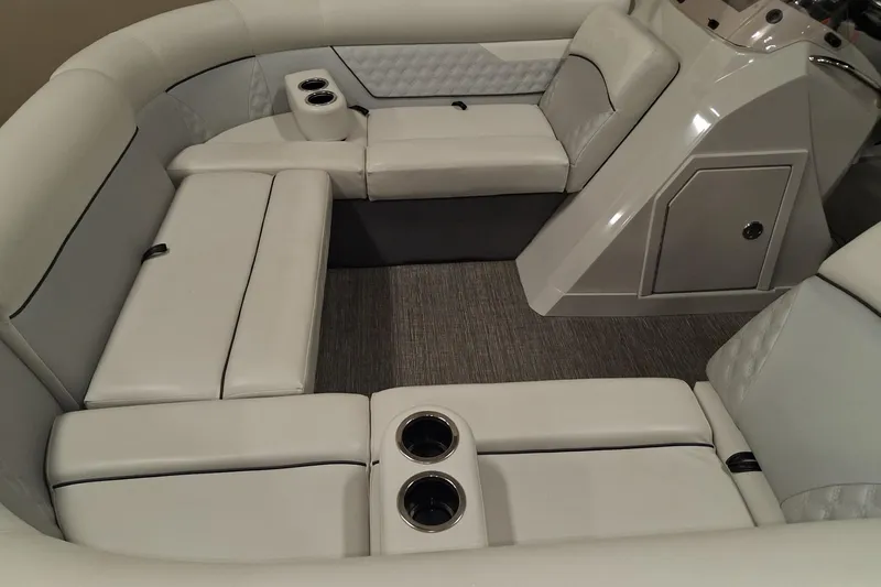 Slide: The Image of Interior of 2022 Crest Classic Platinum 220 boat with luxurious seating and cup holders. - 28
