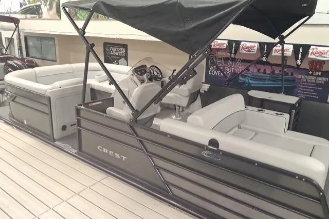 Slide: The Image of 2022 Crest Classic Platinum 220 pontoon boat with spacious seating and canopy. - 3