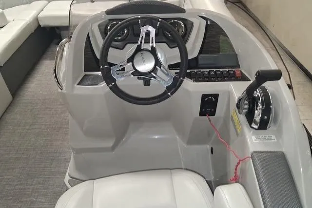 Slide: The Image of Steering console of 2022 Crest Classic Platinum 220 pontoon boat, featuring modern controls and seating. - 7