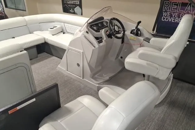 Slide: The Image of Interior of 2022 Crest Classic Platinum 220 pontoon boat with plush seating and modern helm. - 8