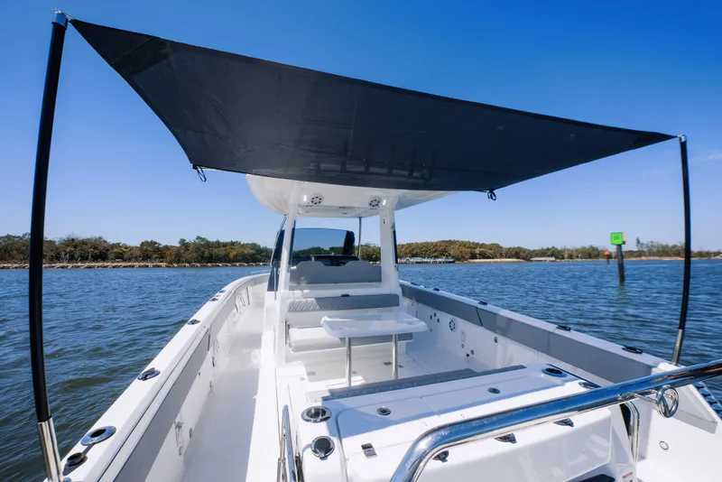 Slide: The Image of Schaefer V33SF 2027 boat with sunshade on calm waters. - 16