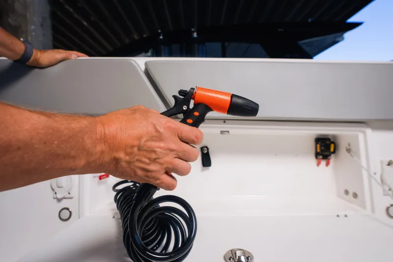 Slide: The Image of Hand holding spray nozzle on Schaefer V33SF boat, 2027 model. - 17