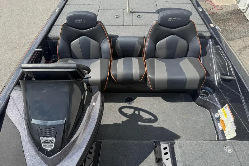 Slide: The Image of 2019 Skeeter ZX225 boat interior with dual seats and steering console. - 10