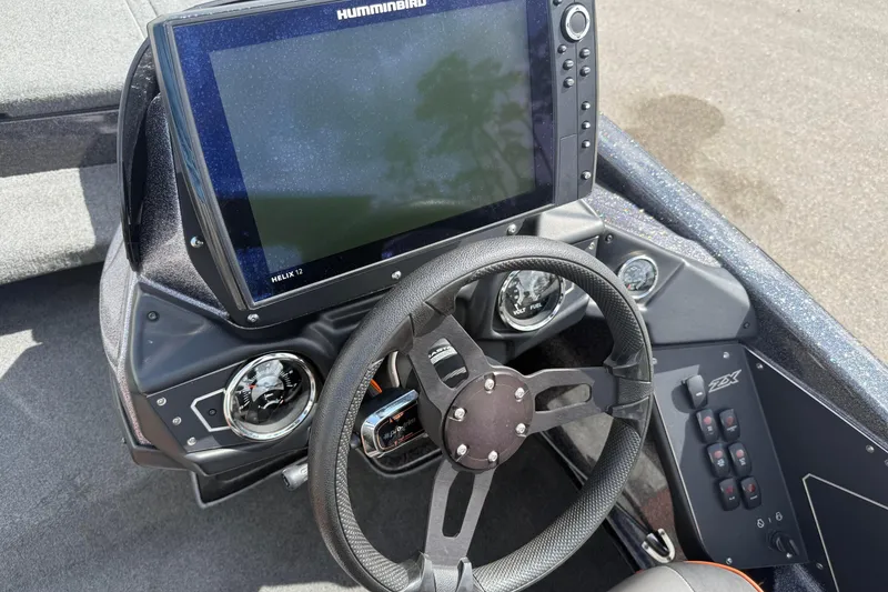 Slide: The Image of 2019 Skeeter ZX225 boat dashboard with Humminbird Helix 12 display and steering wheel. - 11