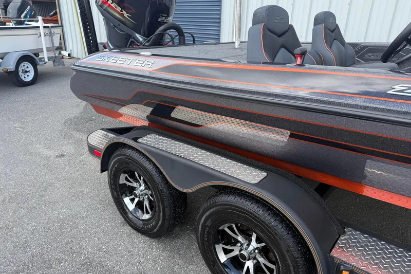Slide: The Image of 2019 Skeeter ZX225 boat with sleek design and dual axle trailer. - 3