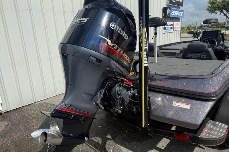 Slide: The Image of 2019 Skeeter ZX225 boat with Yamaha VMAX engine, parked outside a marine dealership. - 4