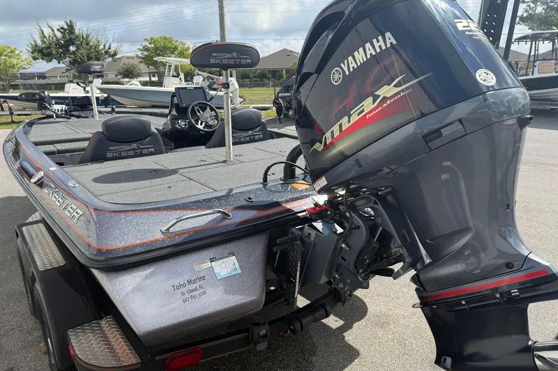 Slide: The Image of 2019 Skeeter ZX225 boat with Yamaha VMAX engine, parked outdoors. - 5