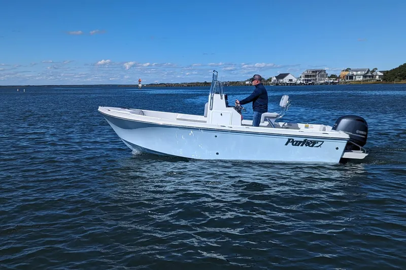The Image of A 2027 Parker 180 Coastal boat cruising on a calm blue sea under a clear sky. - 1