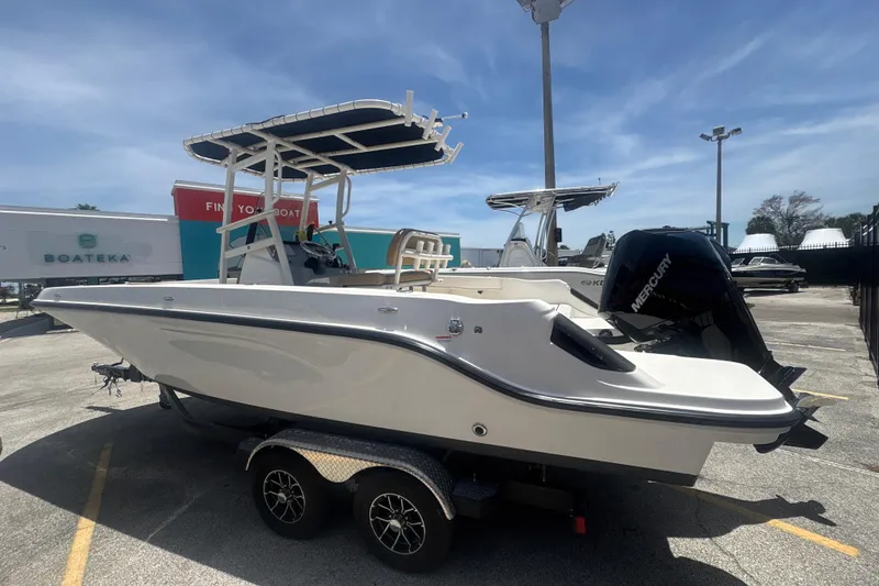 Slide: The Image of 2023 Bayliner Trophy T22CC boat on trailer, displayed outdoors under clear sky. - 3