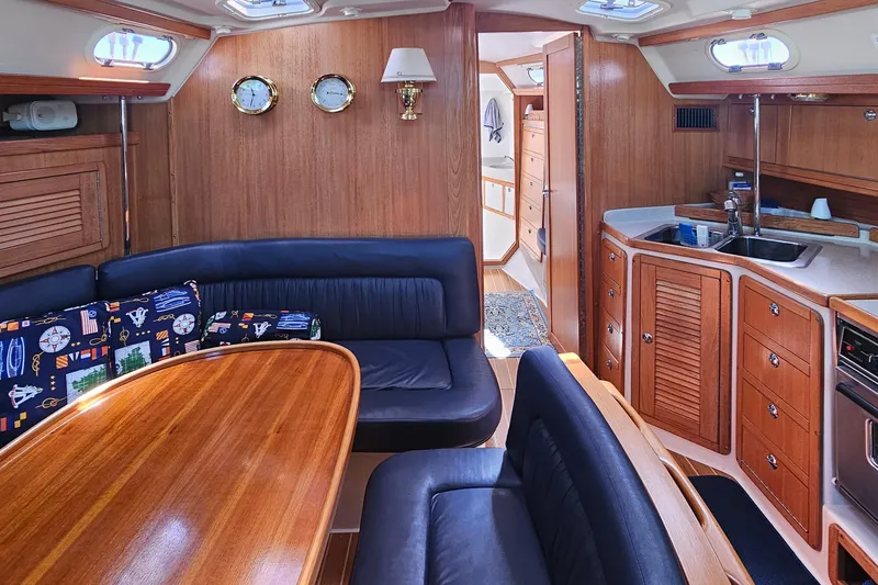Slide: The Image of Interior of a 2006 Catalina 42 MkII sailboat with wood finish and cozy seating area. - 19