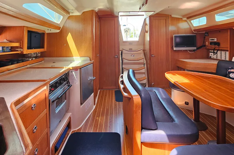 Slide: The Image of Interior of a 2006 Catalina 42 MkII sailboat with wood finishes and modern amenities. - 23