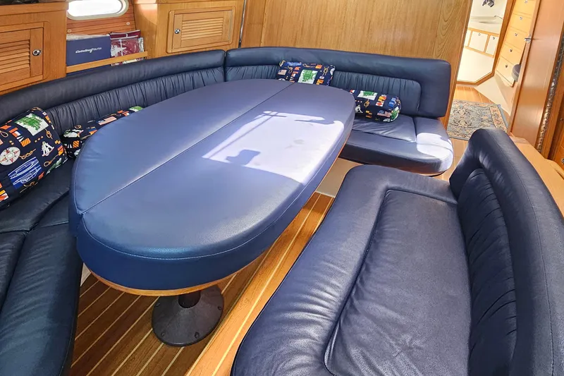 Slide: The Image of Luxurious 2006 Catalina 42 MkII yacht interior with blue seating and wooden accents. - 25