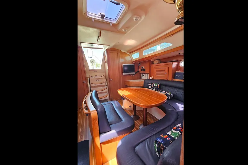 Slide: The Image of Interior of 2006 Catalina 42 MkII sailboat with cozy seating and wooden table. - 27