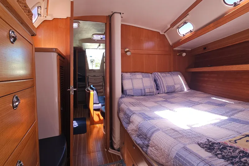 Slide: The Image of Cozy cabin interior of 2006 Catalina 42 MkII sailboat with wood finish and bed. - 29