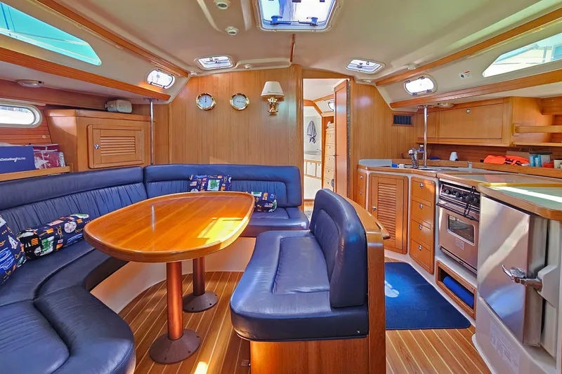Slide: The Image of Interior of a 2006 Catalina 42 MkII sailboat with cozy seating and wooden finishes. - 3