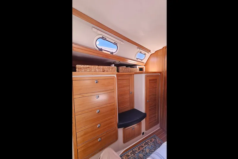 Slide: The Image of Interior of 2006 Catalina 42 MkII sailboat with wooden cabinets and portholes. - 30