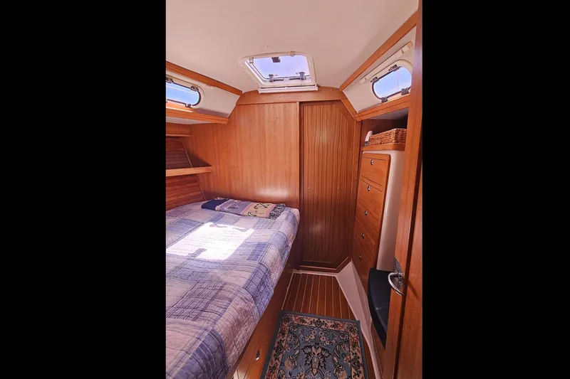 Slide: The Image of Cozy cabin interior of 2006 Catalina 42 MkII sailboat with wood paneling and bed. - 32