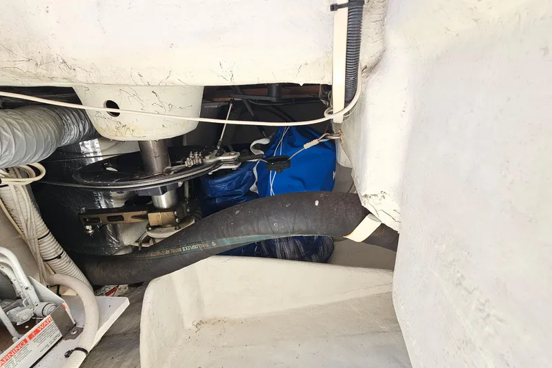 Slide: The Image of Engine compartment of a 2006 Catalina 42 MkII sailboat, showing mechanical components and hoses. - 40