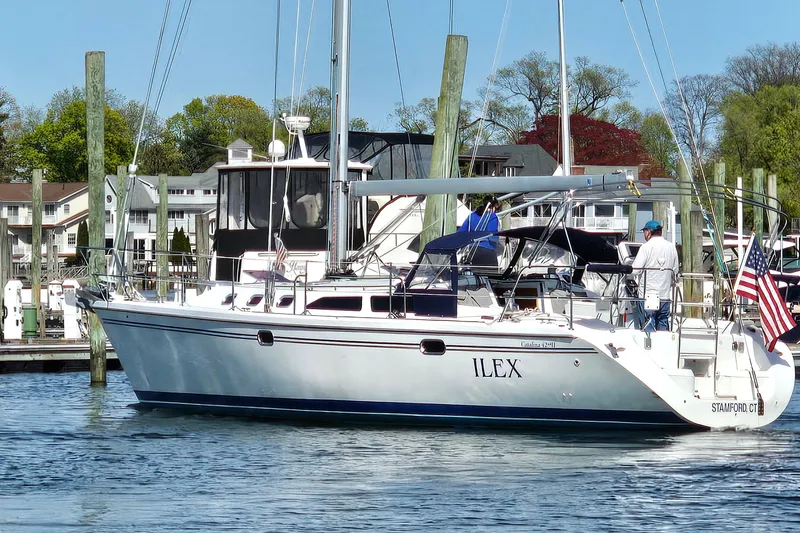 Slide: The Image of 2006 Catalina 42 MkII sailboat docked in a marina with American flag. - 6