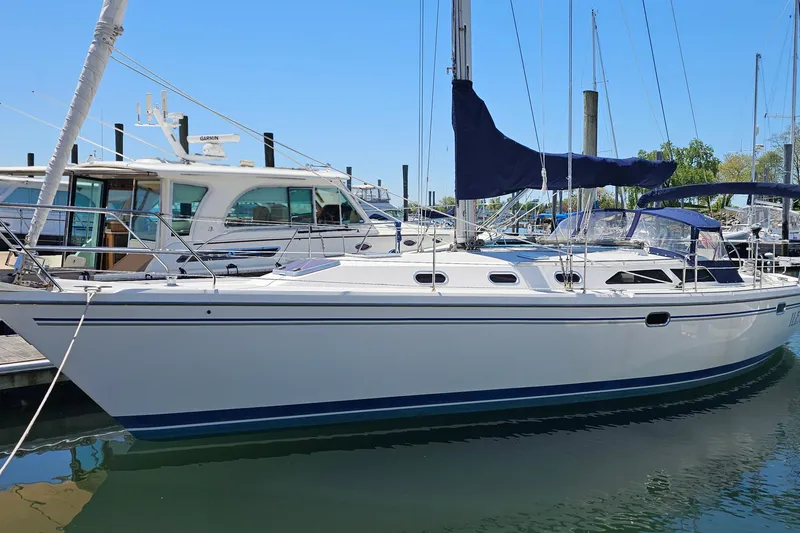 Slide: The Image of 2006 Catalina 42 MkII sailboat docked at marina under clear blue sky. - 7