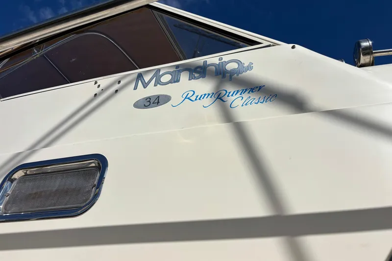 Slide: The Image of 2006 Mainship Pilot 34 Sedan boat with "Rum Runner Classic" text on the side. - 5