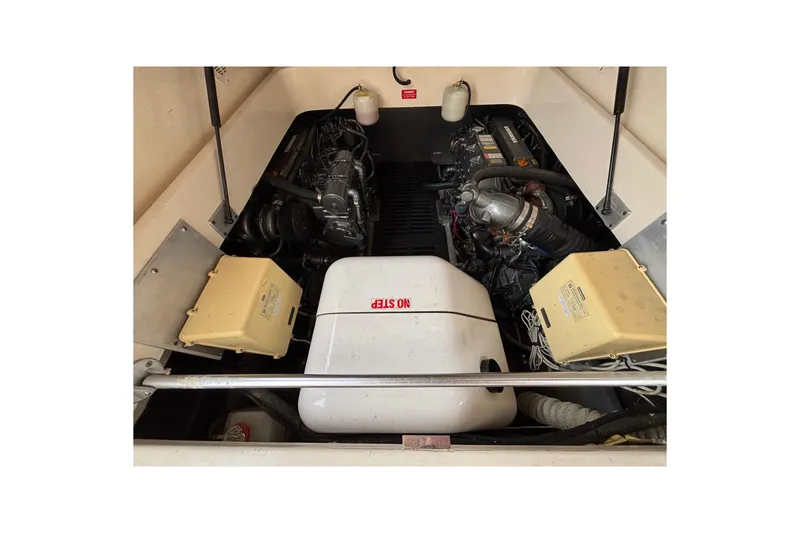 Slide: The Image of Engine compartment of 2006 Mainship Pilot 34 Sedan, showcasing mechanical components and wiring. - 9