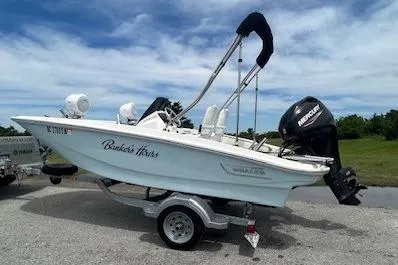 The Image of 2020 Boston Whaler 130 Super Sport boat on trailer, parked outdoors. - 0