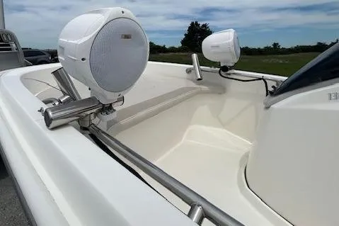 Slide: The Image of 2020 Boston Whaler 130 Super Sport boat with speakers, sleek design, and open deck. - 11