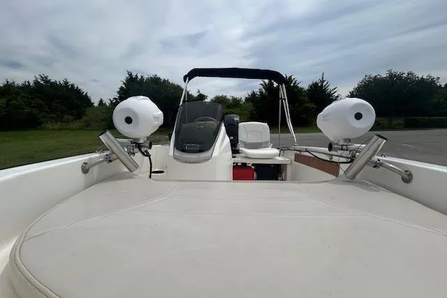 Slide: The Image of 2020 Boston Whaler 130 Super Sport boat interior with seating and steering console. - 12