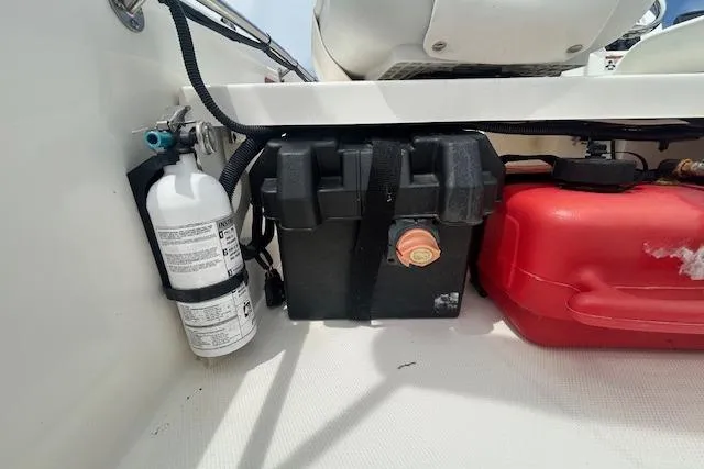 Slide: The Image of 2020 Boston Whaler 130 Super Sport interior with fire extinguisher, battery, and fuel tank. - 4