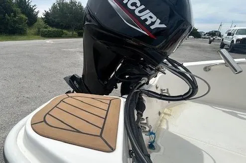 Slide: The Image of 2020 Boston Whaler 130 Super Sport boat with Mercury engine, docked outdoors. - 5