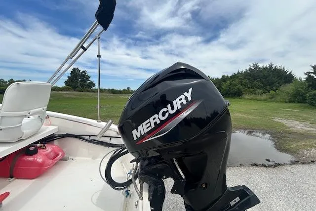 Slide: The Image of 2020 Boston Whaler 130 Super Sport with Mercury outboard motor, parked outdoors. - 6