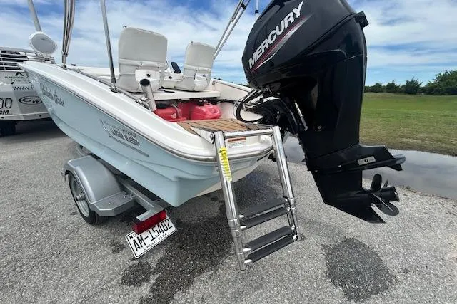 Slide: The Image of 2020 Boston Whaler 130 Super Sport boat with Mercury engine on trailer. - 7