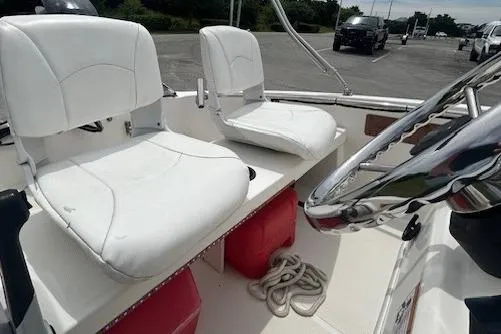 Slide: The Image of 2020 Boston Whaler 130 Super Sport interior with white seats and steering wheel. - 8