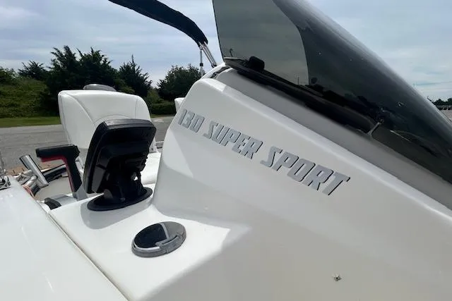 Slide: The Image of 2020 Boston Whaler 130 Super Sport boat dashboard with steering wheel and windshield. - 9