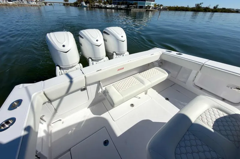 Slide: The Image of Manufacturer Provided Image: 2026 Jupiter 34 boat with triple outboard engines on calm water. - 11