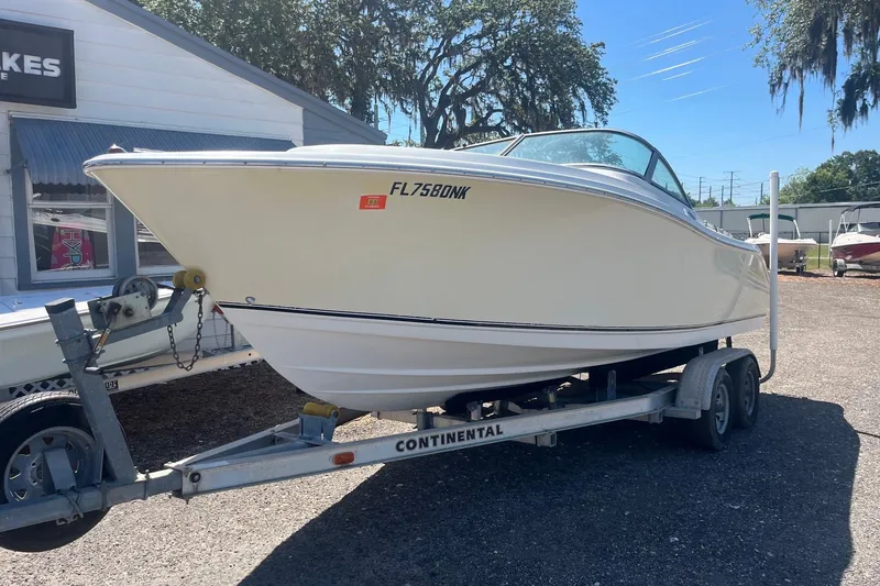 Slide: The Image of 2007 NauticStar 2000XSDC Offshore boat on trailer, parked outdoors. - 12