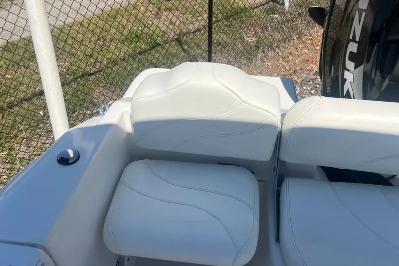 Slide: The Image of White seating on a 2007 NauticStar 2000XSDC Offshore boat, near a fence. - 4