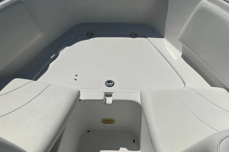 Slide: The Image of 2007 NauticStar 2000XSDC Offshore boat interior with white seating and storage compartment. - 6