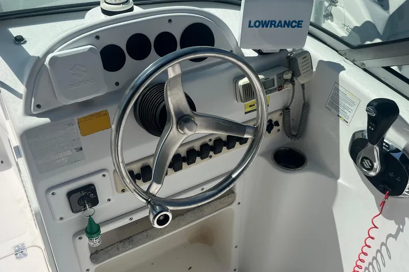 Slide: The Image of Control panel of a 2007 NauticStar 2000XSDC Offshore boat with steering wheel and Lowrance equipment. - 8