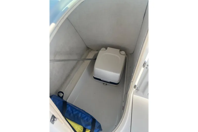 Slide: The Image of 2007 NauticStar 2000XSDC Offshore boat interior with portable toilet and storage area. - 9