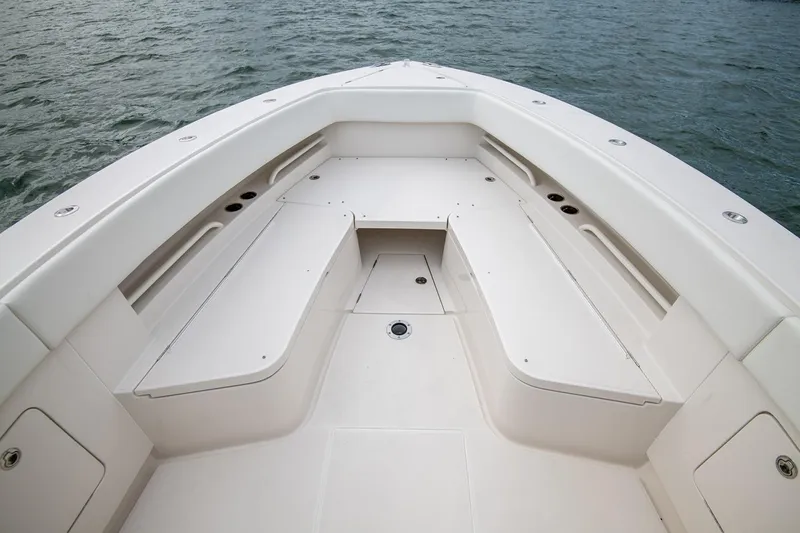 Slide: The Image of Manufacturer Provided Image: 2026 Jupiter 38 boat bow seating area with white cushions on calm water. - 3