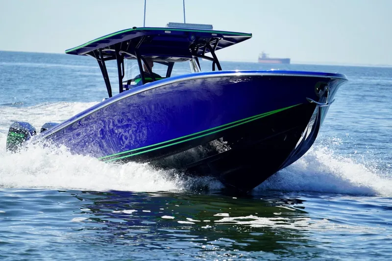 Slide: The Image of 2023 Nor-Tech 390 Sport Center Console boat cruising on open water. - 10