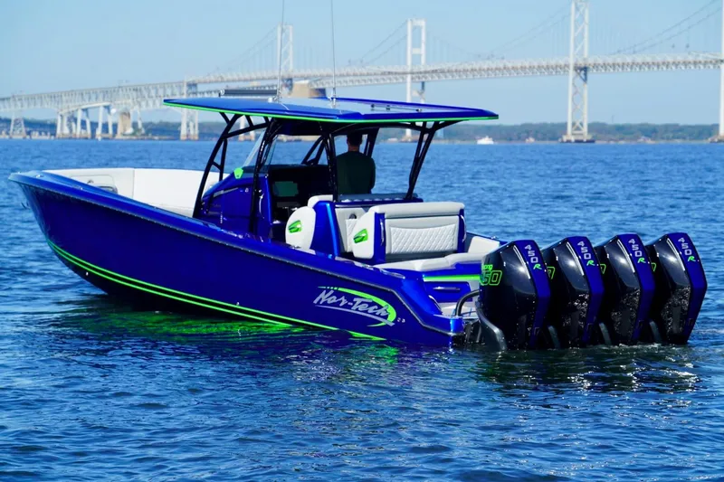 Slide: The Image of 2023 Nor-Tech 390 Sport Center Console boat on water with bridge in background. - 15